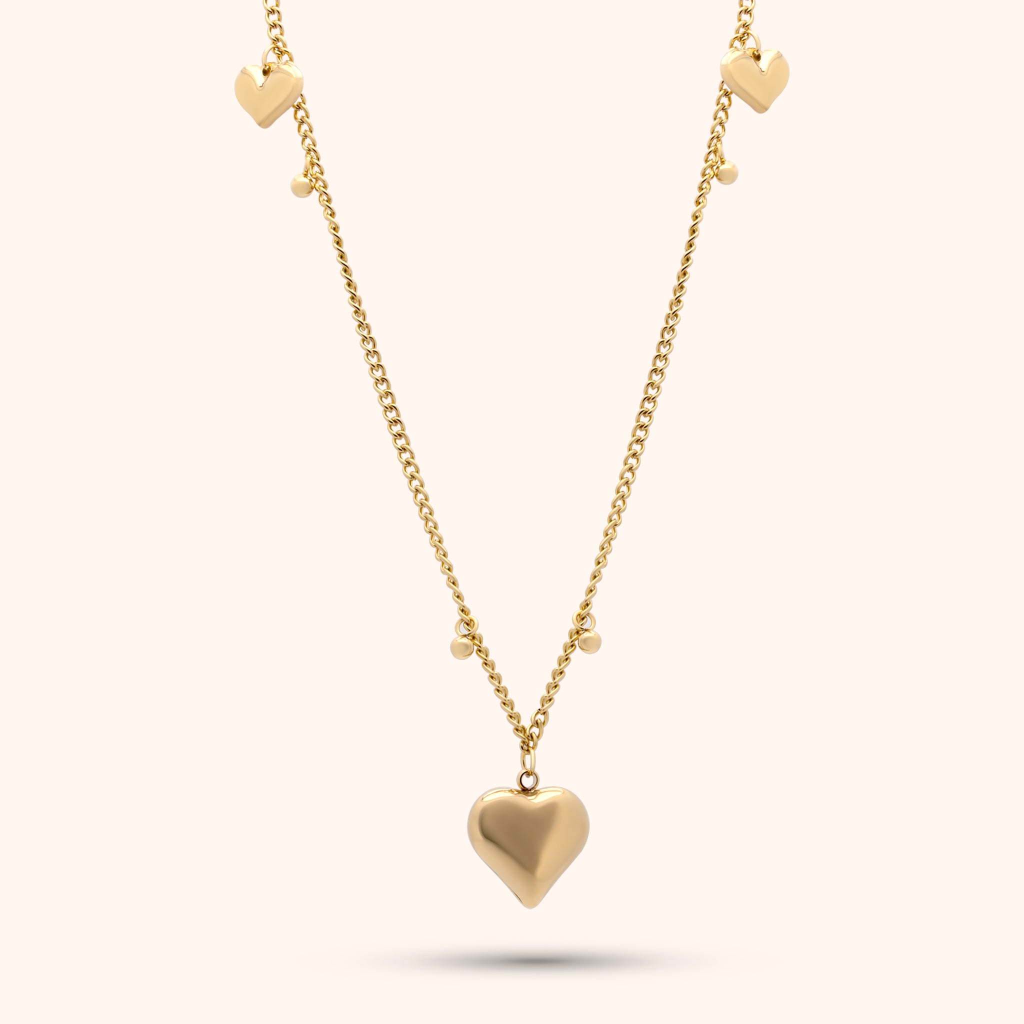 Pressie Delicate Symmetrical Heart Charm Necklace, 18K gold plated stainless steel, close-up of the heart charm details.